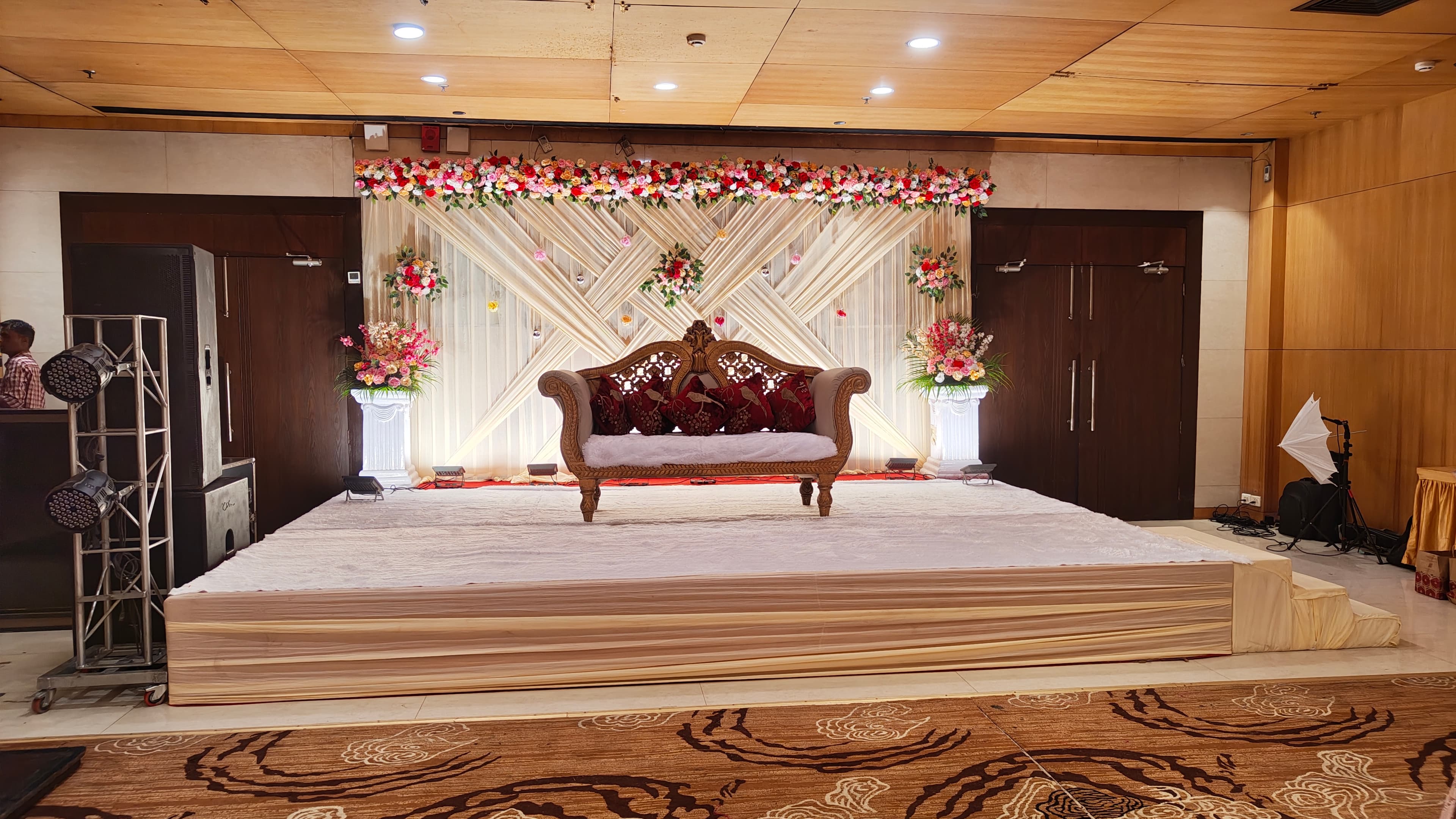 Floral stage backdrop and loveseat on the Grand Ball Room stage