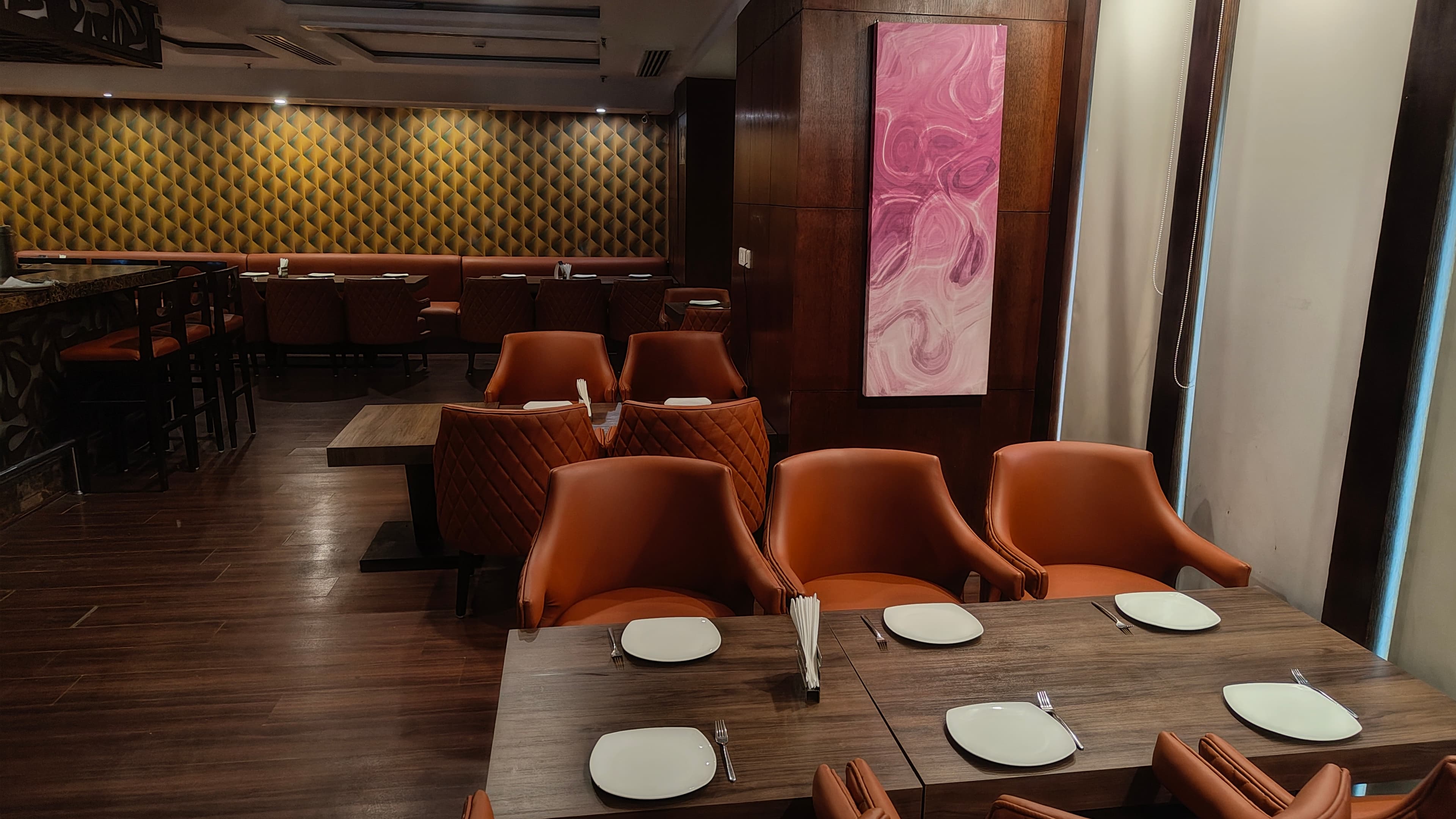 Dining area at Real Spice with contemporary art wall
