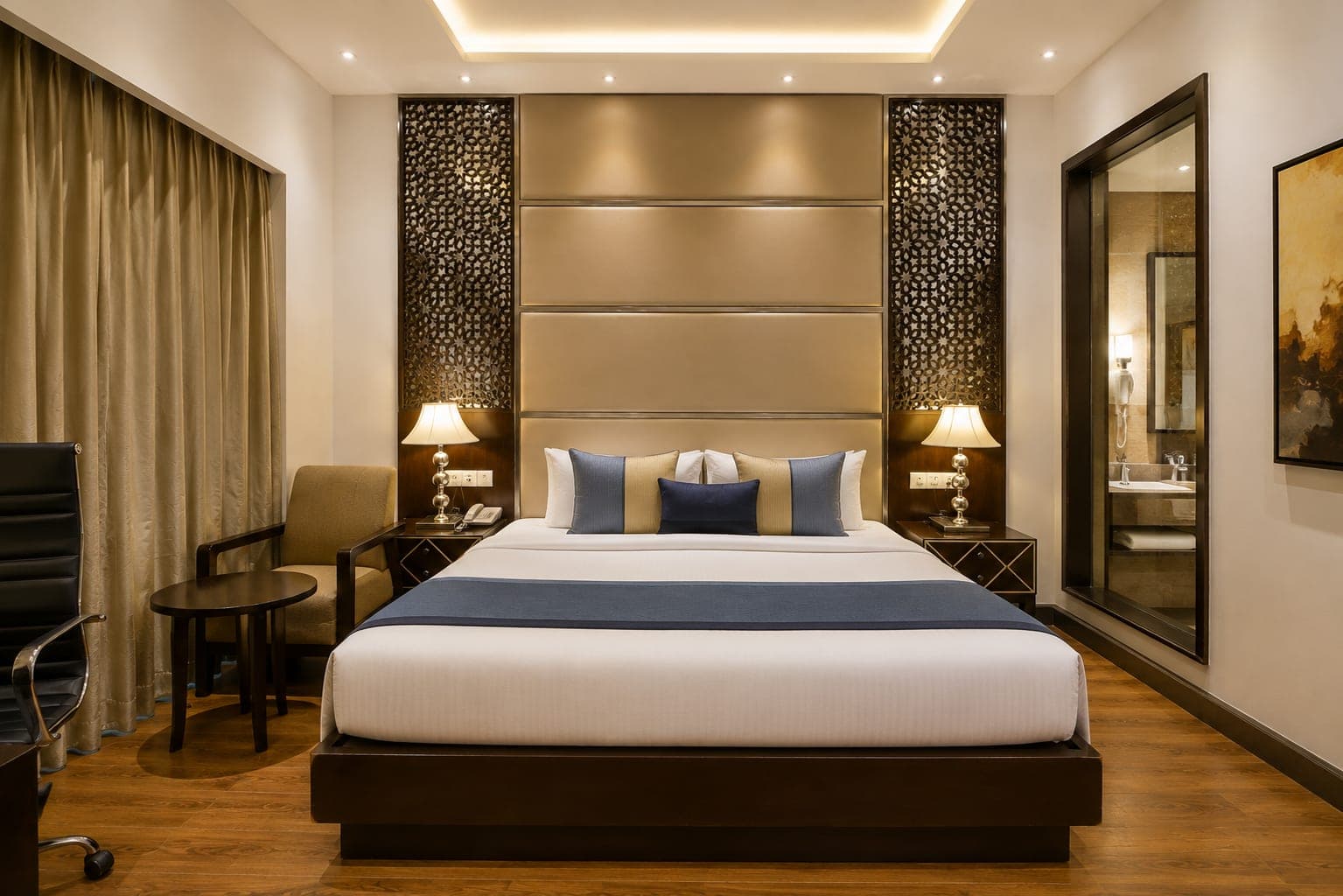 Comfortable hotel room with bed and seating area at Delite Grand, Faridabad
